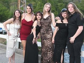 Group of students posing on the bridge for a photo. 
