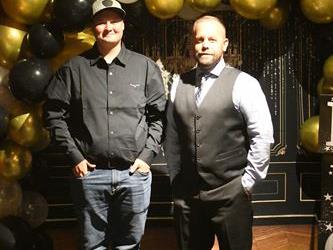Matt & Bryon prom photo with balloons behind them.
