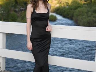 Student posing on the bridge for a photo. 