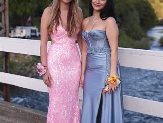 Two students posing on the bridge for a photo.